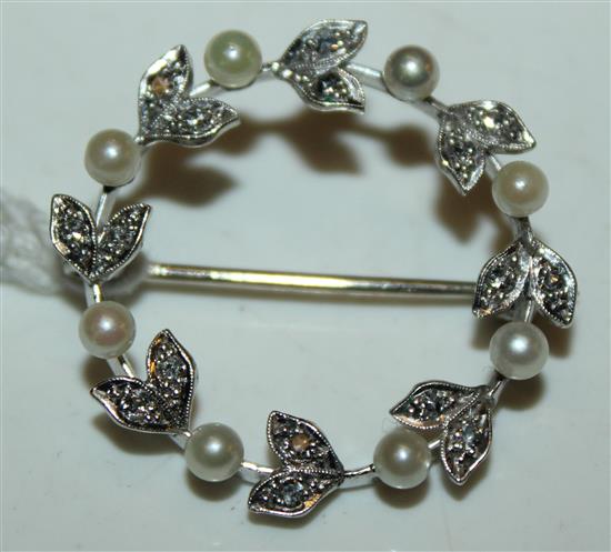 A 9ct white gold, diamond and seed pearl set open circular brooch(-)